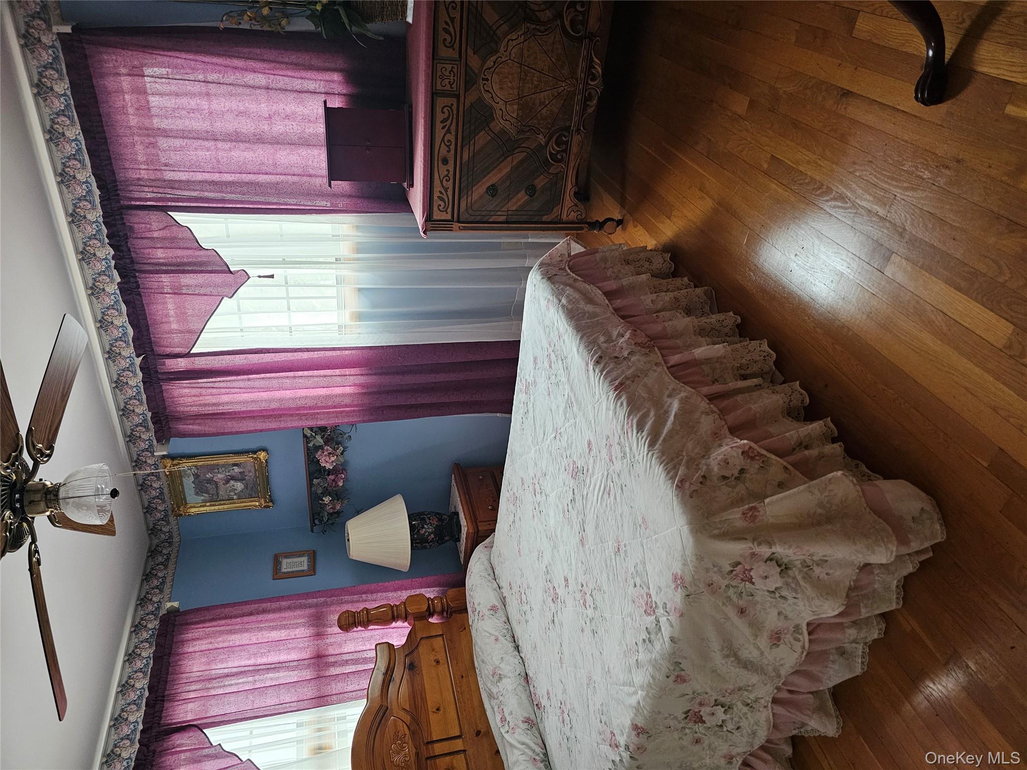 21 Philcox Road Middletown, NY 10940 - Photo 2 of 3 a bedroom with a bed and wooden floor