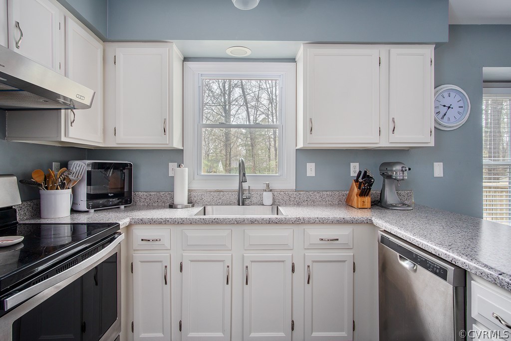 4404 Rabbit Foot Place Chesterfield, VA 23236 - Photo 12 of 32 a kitchen with granite countertop white cabinets and white appliances