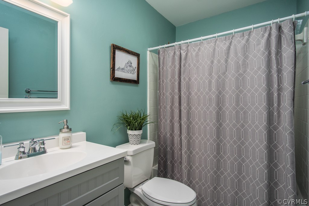 4404 Rabbit Foot Place Chesterfield, VA 23236 - Photo 23 of 32 a bathroom with a sink a toilet and shower curtain