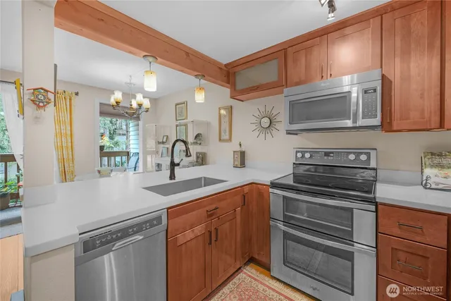 a kitchen with stainless steel appliances granite countertop a sink and cabinets