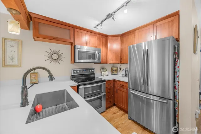 a kitchen with stainless steel appliances a refrigerator sink and cabinets