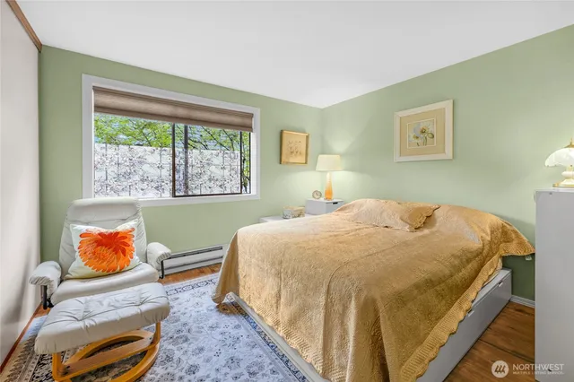 a bed sitting in a bedroom next to a window