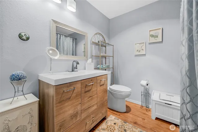 a bathroom with a toilet sink and mirror