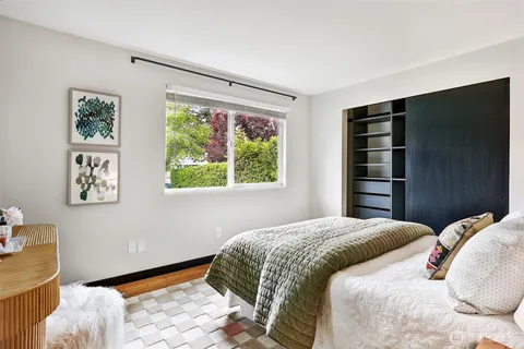 a bedroom with a bed and a window