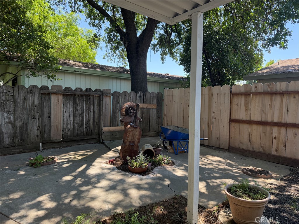 3835 Gardiner Ferry Road, Unit 98 Corning, CA 96021 - Photo 11 of 11 a view of a backyard with table and chairs and a large tree