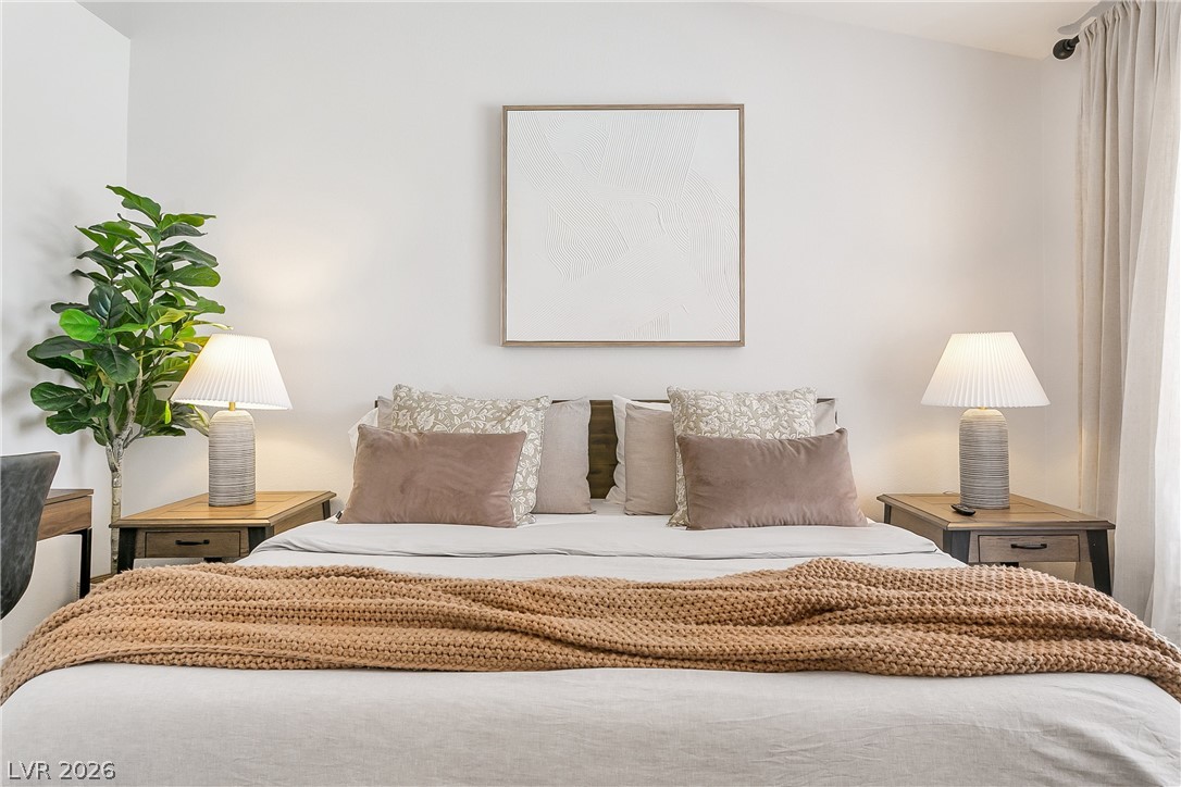 101 Beaver Ridge Avenue North Las Vegas, NV 89031 - Photo 13 of 42 Relax in this well-lit bedroom featuring high ceilings and elegant natural light.