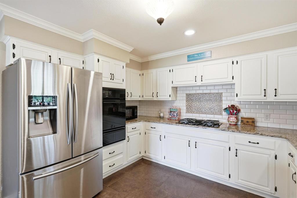 432 Clark Road Abilene, TX 79602 - Photo 10 of 40 a kitchen with cabinets a refrigerator and a sink