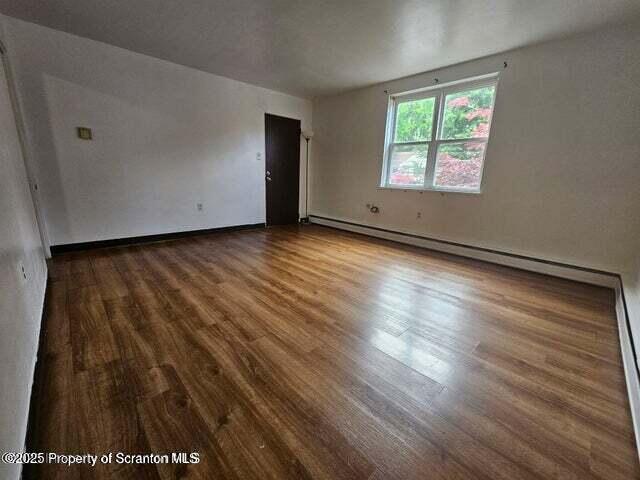 240 East Grove Street, Unit 4 Clarks Summit, PA 18411 - Photo 3 of 8 an empty room with wooden floor and windows