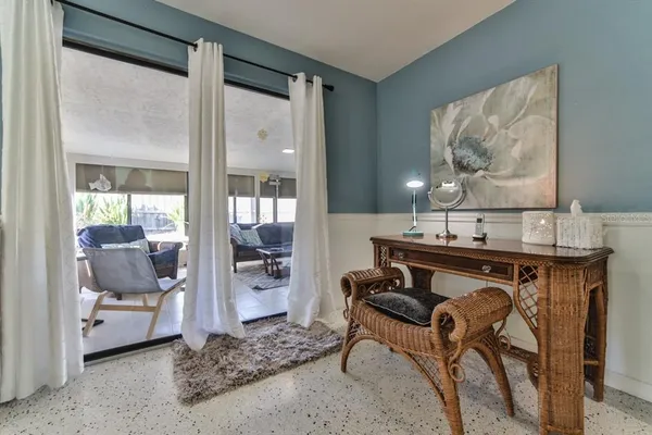 a living room with furniture and a painting on the wall