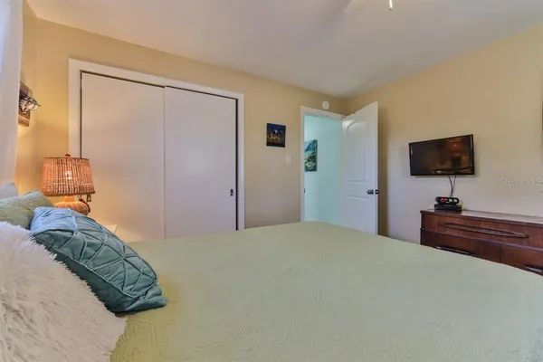 a view of entryway bedroom and hall with wooden floor