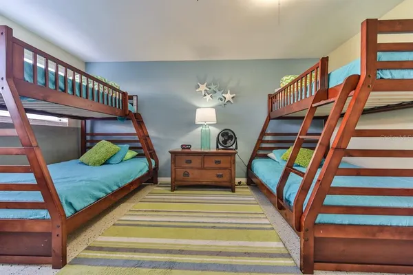 a bedroom with a bunk bed and a chair