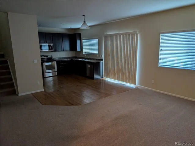 a kitchen with kitchen island granite countertop a sink and a stove top oven