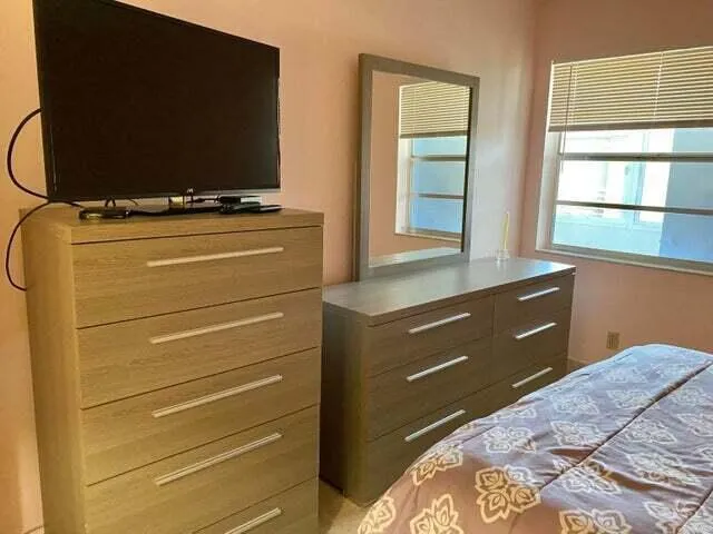 a bathroom with a sink mirror and toilet