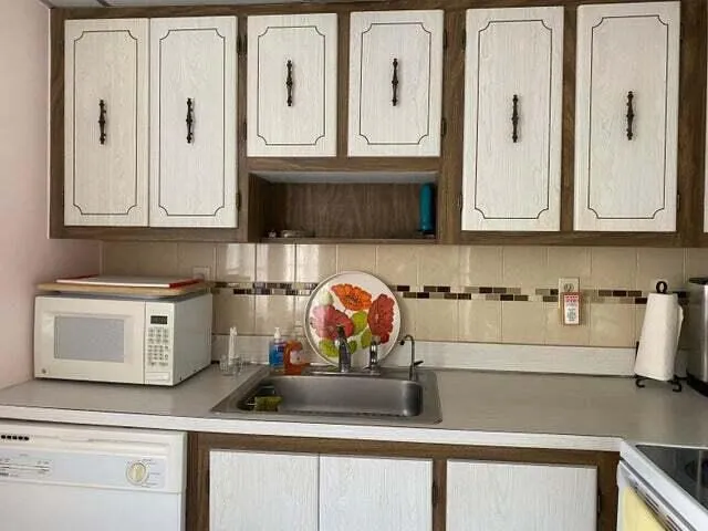 a kitchen with appliances cabinets and a sink