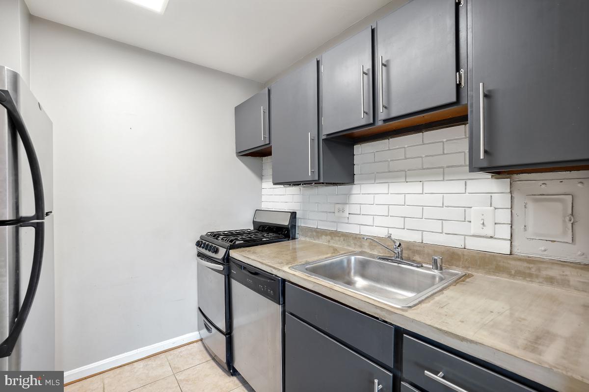 1900 Lyttonsville Road, Unit 1101 Silver Spring, MD 20910 - Photo 5 of 24 a kitchen with a sink a stove and cabinets