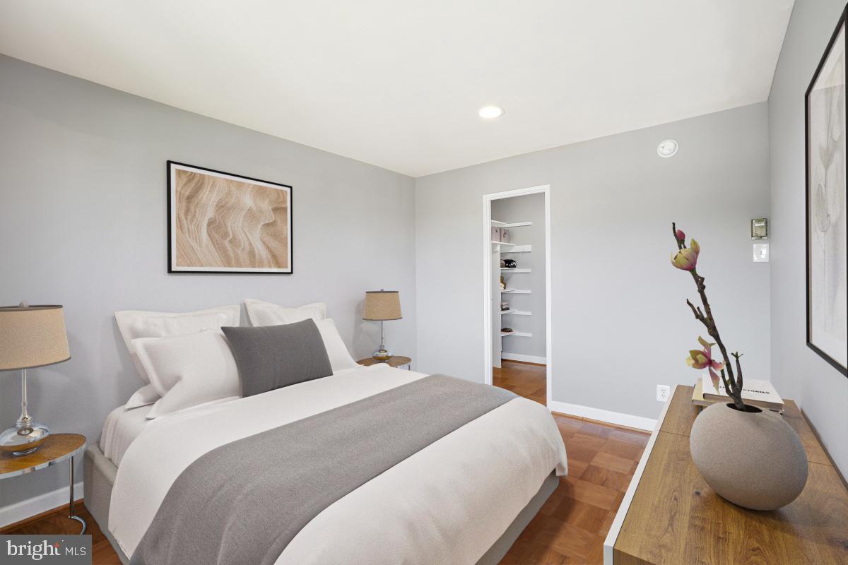 1900 Lyttonsville Road, Unit 1101 Silver Spring, MD 20910 - Photo 9 of 24 a bedroom with bed and a couch