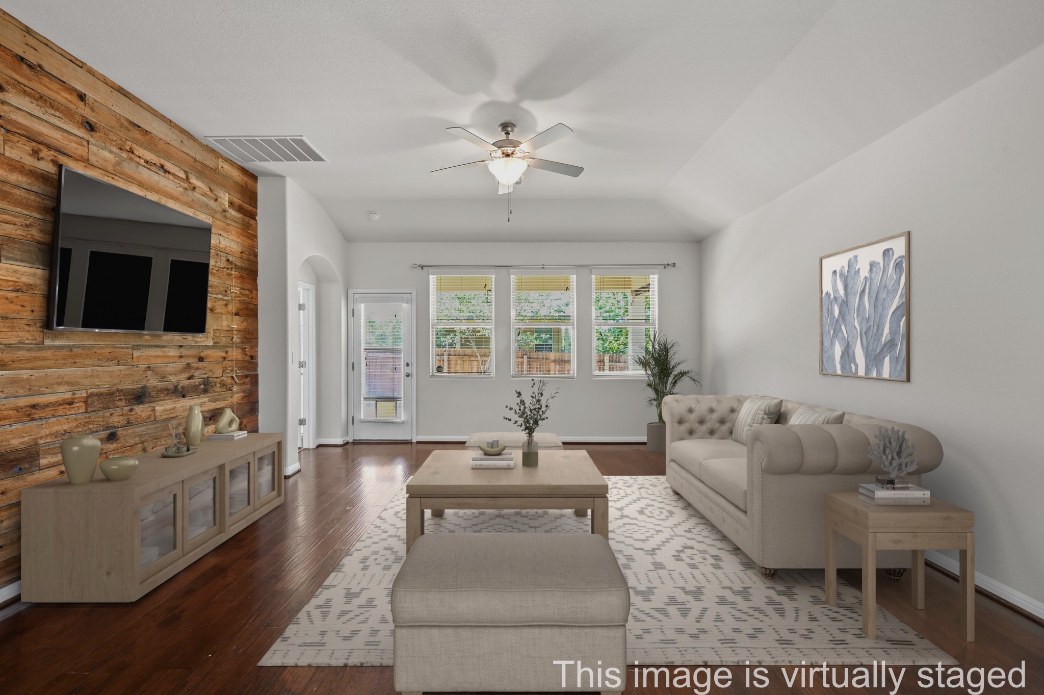 351 Wincliff Drive Buda, TX 78610 - Photo 8 of 40 Hardwood floors and a textured accent wall create an inviting ambiance in this spacious living area.