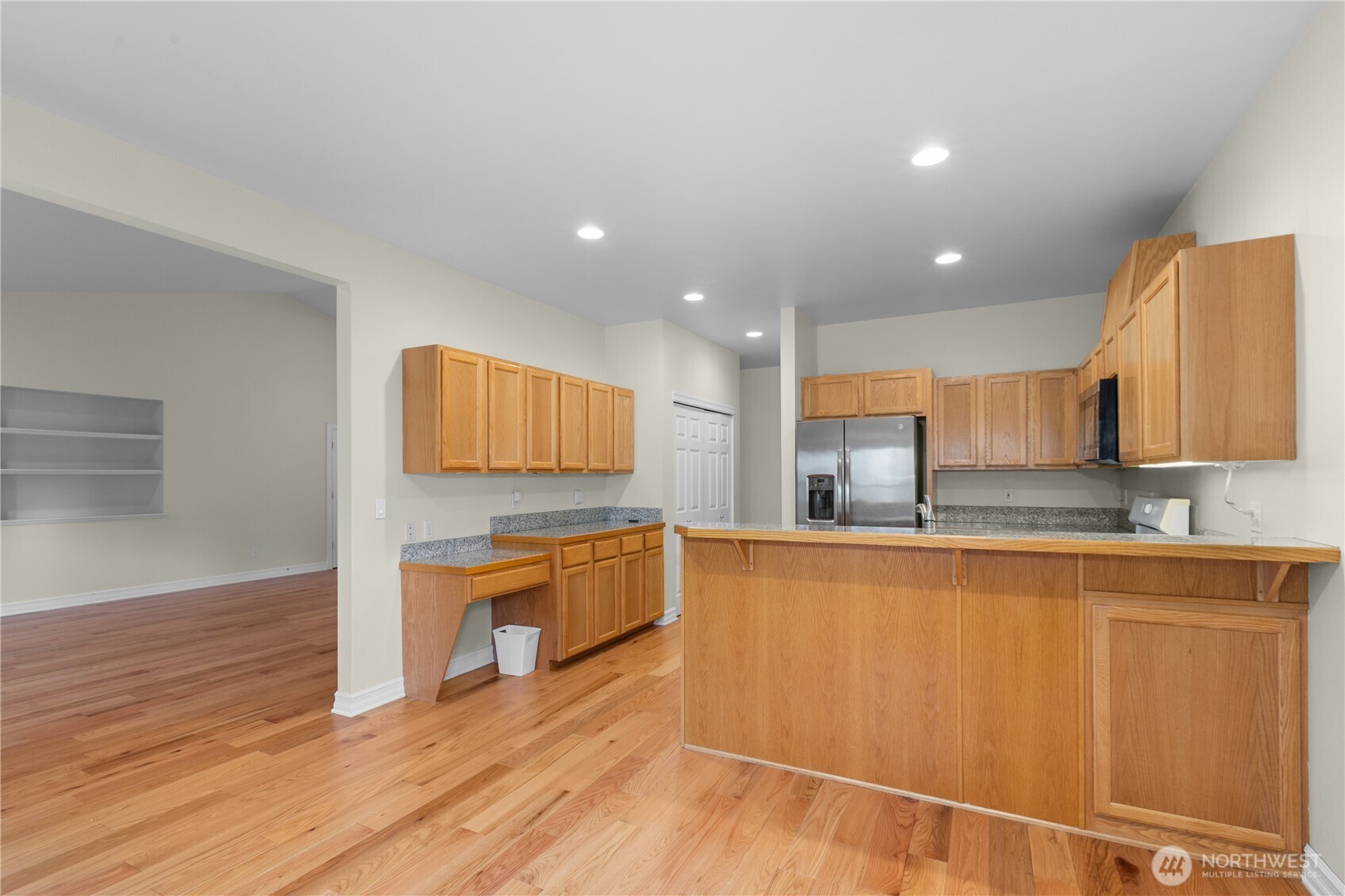 13796 Seaview Way Anacortes, WA 98221 - Photo 11 of 39 a kitchen with stainless steel appliances granite countertop a sink and cabinets with wooden floor