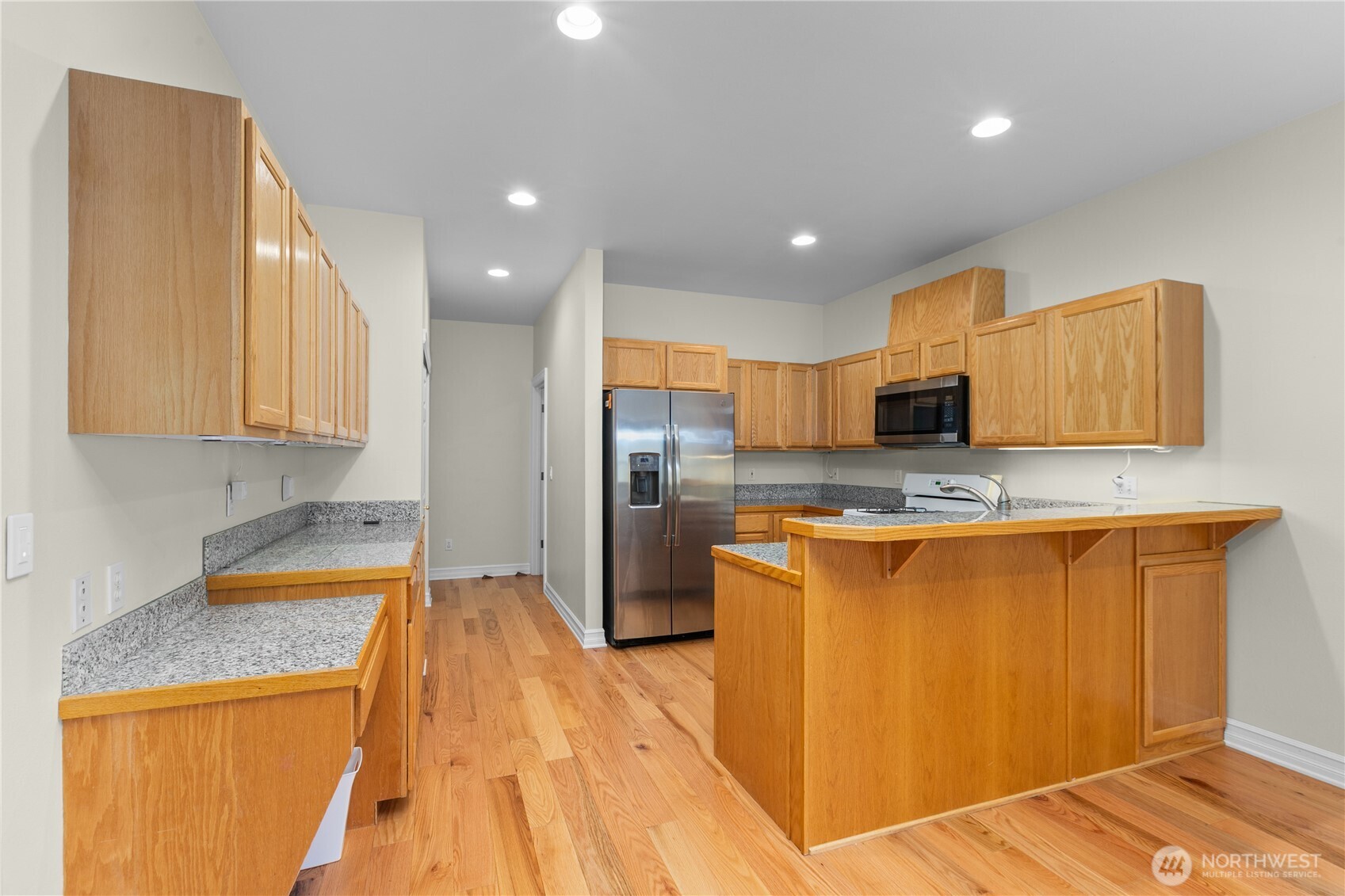 13796 Seaview Way Anacortes, WA 98221 - Photo 12 of 39 a kitchen with stainless steel appliances granite countertop a refrigerator a stove and a sink