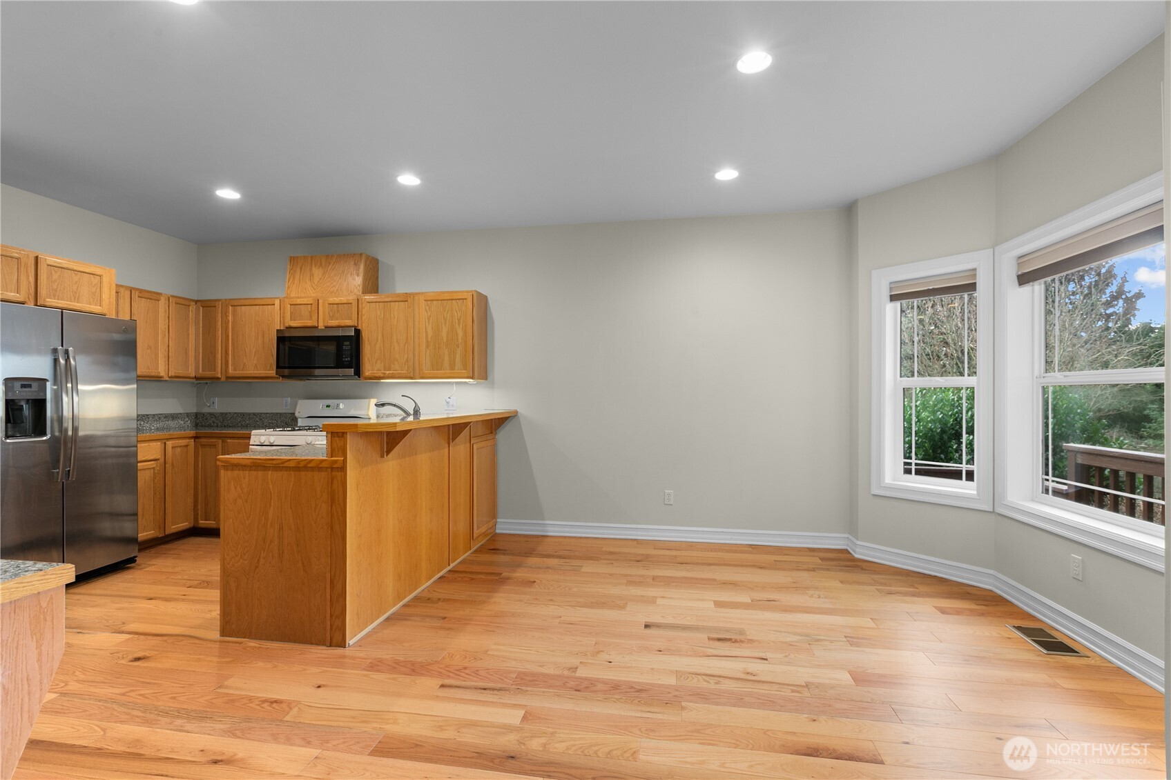 13796 Seaview Way Anacortes, WA 98221 - Photo 14 of 39 a kitchen with stainless steel appliances granite countertop a stove a sink and a refrigerator