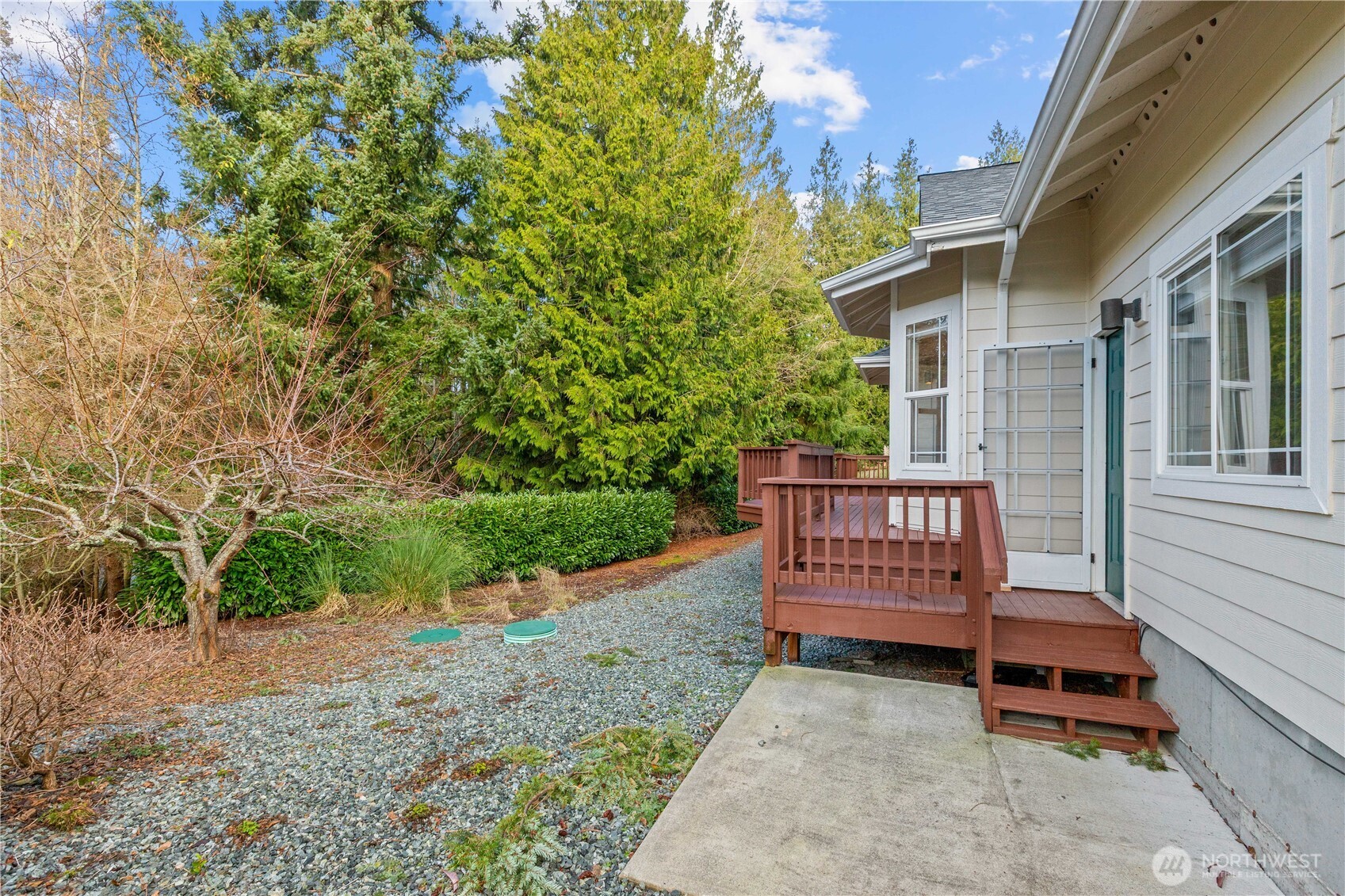 13796 Seaview Way Anacortes, WA 98221 - Photo 30 of 39 a view of a wooden bench in a backyard