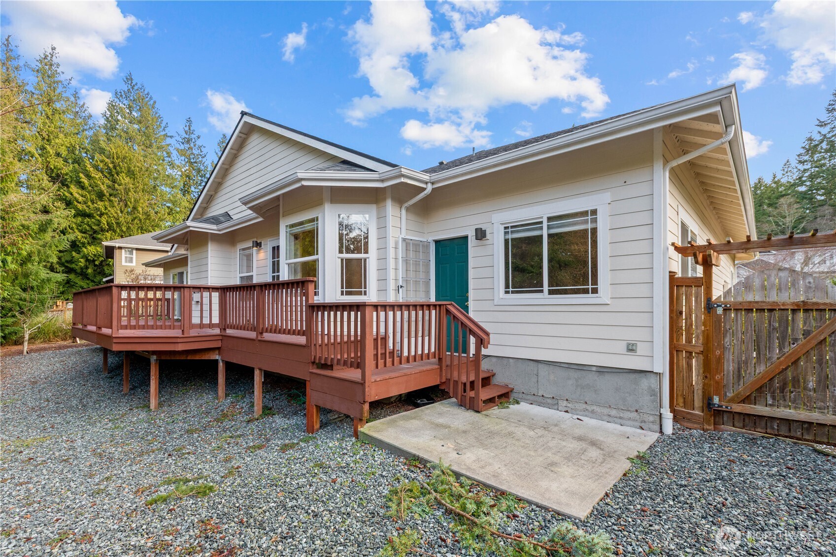 13796 Seaview Way Anacortes, WA 98221 - Photo 31 of 39 a view of a house with a bed and wooden deck