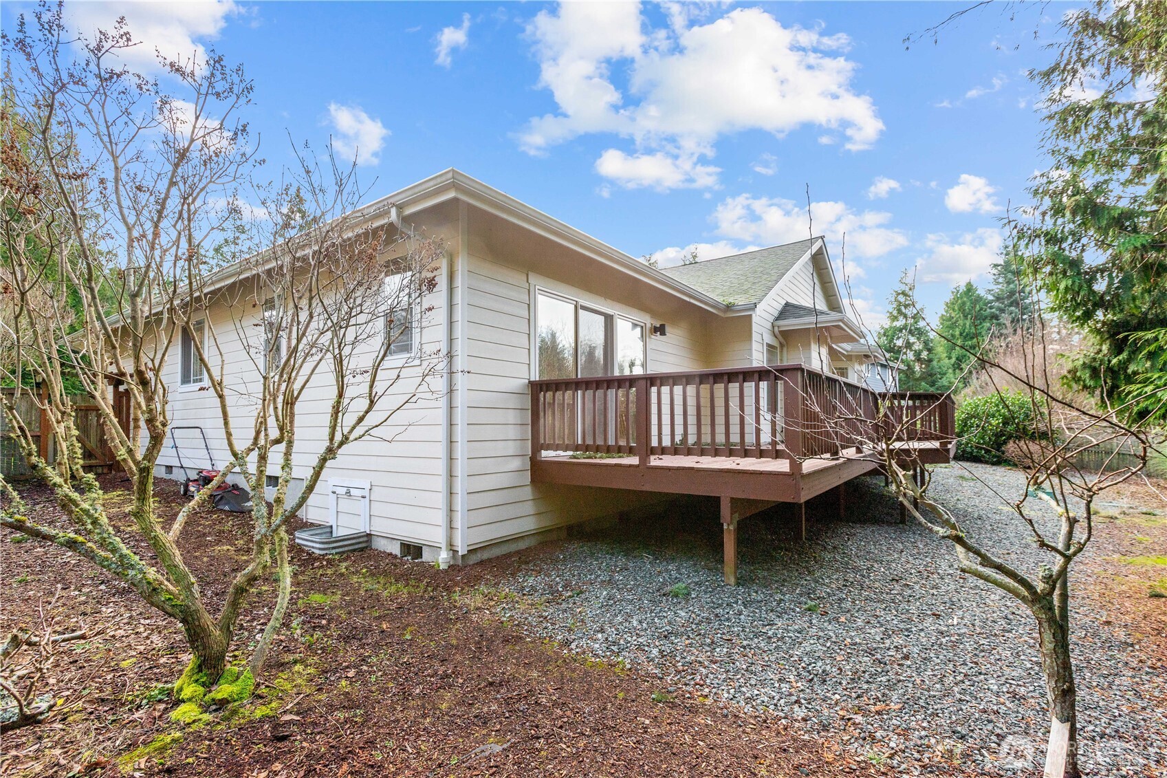 13796 Seaview Way Anacortes, WA 98221 - Photo 32 of 39 a view of a house with a yard and wooden deck