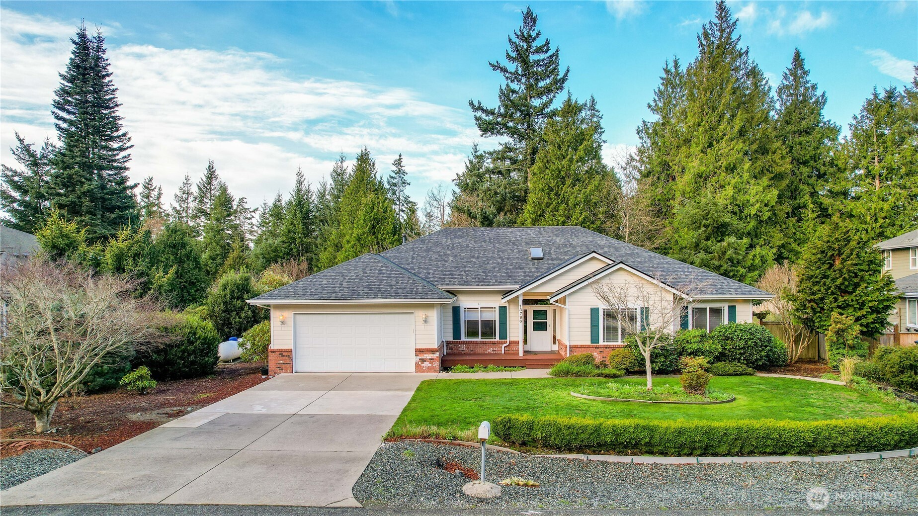 13796 Seaview Way Anacortes, WA 98221 - Photo 33 of 39 a front view of a house with a yard and garage