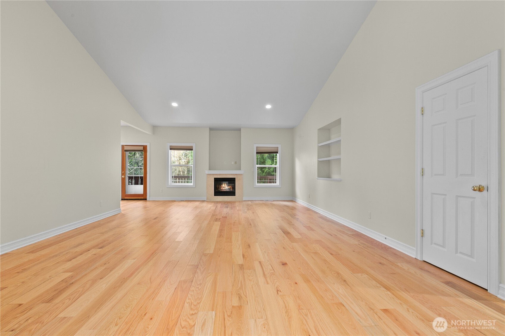 13796 Seaview Way Anacortes, WA 98221 - Photo 7 of 39 a view of empty room with wooden floor and kitchen