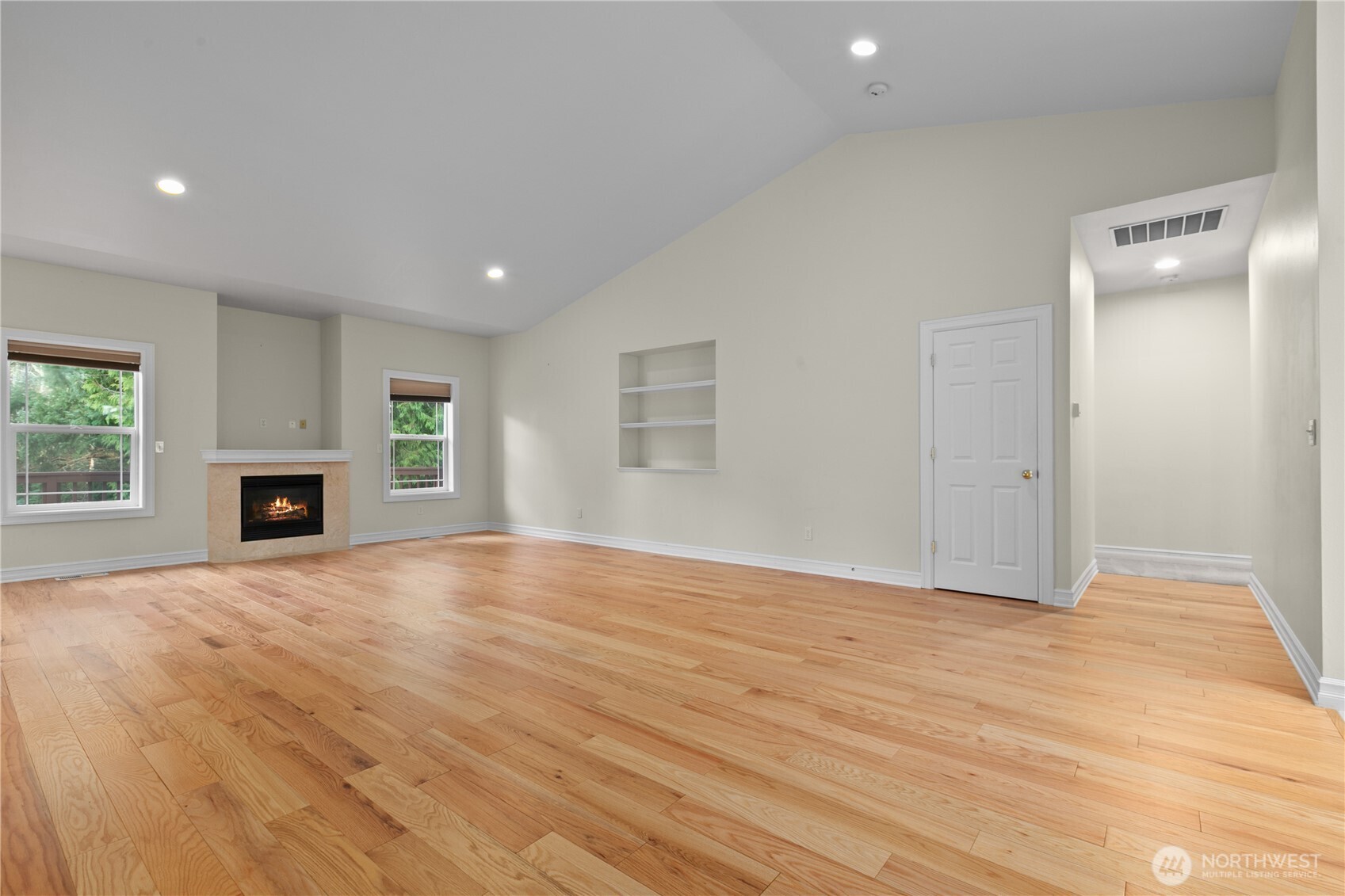 13796 Seaview Way Anacortes, WA 98221 - Photo 8 of 39 an empty room with wooden floor and fireplace