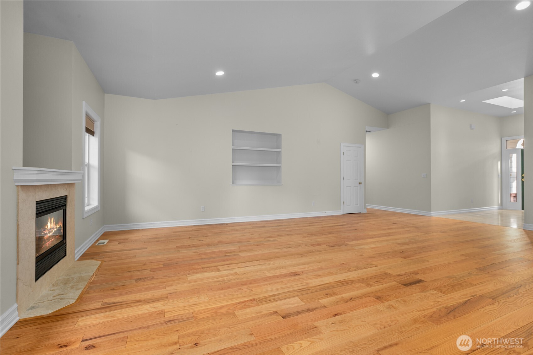 13796 Seaview Way Anacortes, WA 98221 - Photo 9 of 39 a view of empty room with wooden floor and fireplace