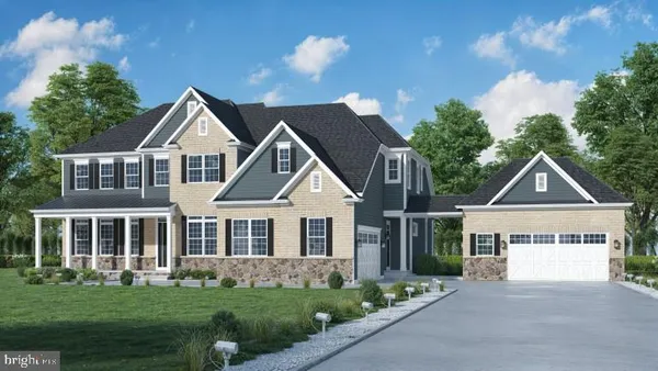 a front view of a house with a garden and yard