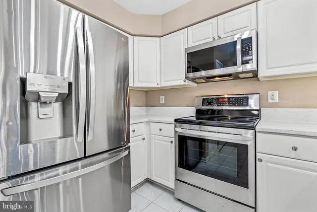 a kitchen with stainless steel appliances a refrigerator stove and microwave