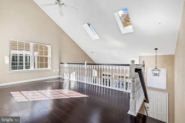 a view of a hallway with windows and stairs