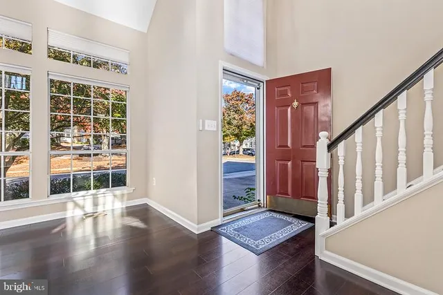 a view of an entryway with wooden floor and door