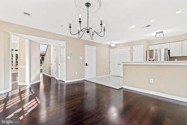 a view of a room with wooden floor and windows