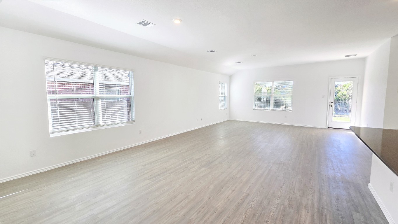 1637 Chapel Ranch Road Georgetown, TX 78628 - Photo 3 of 14 an empty room with wooden floor and windows