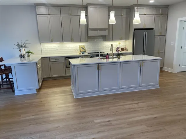 a kitchen with a sink cabinets and wooden floor