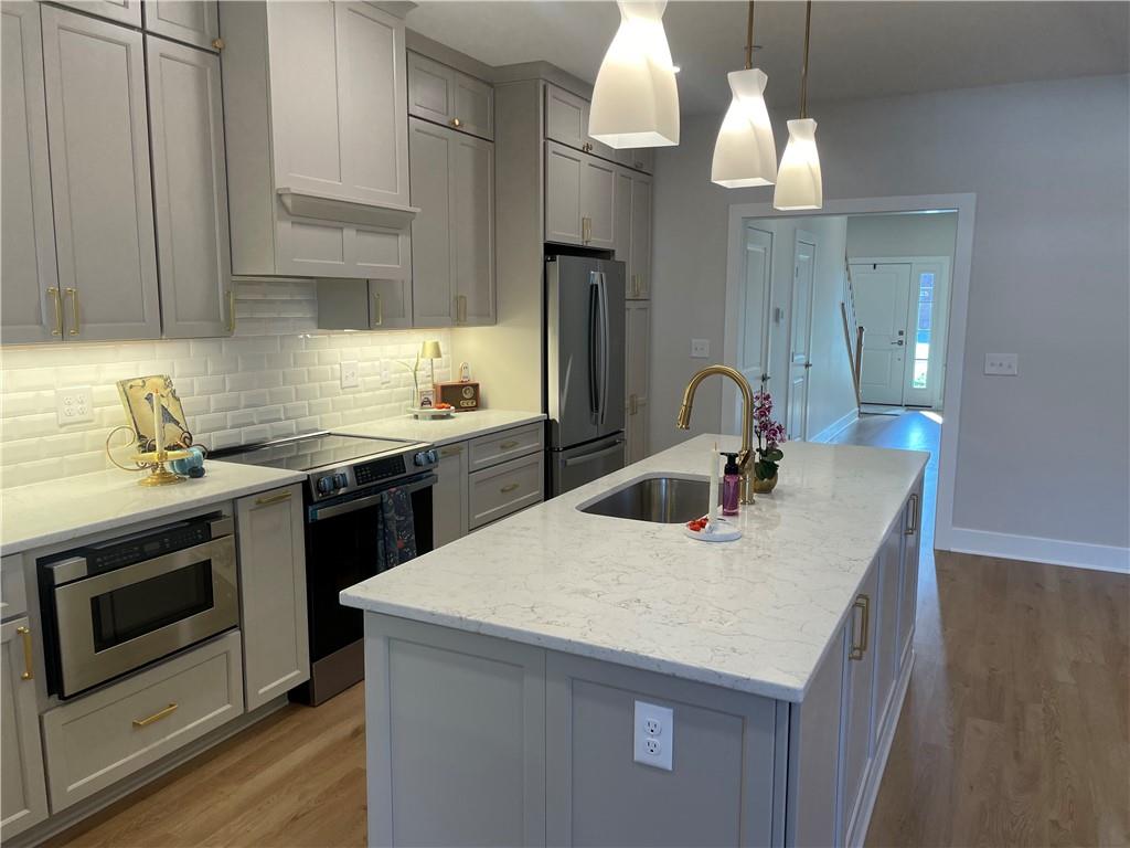 810 2nd Street Beaver, PA 15009 - Photo 5 of 7 a kitchen with a sink a stove and cabinets