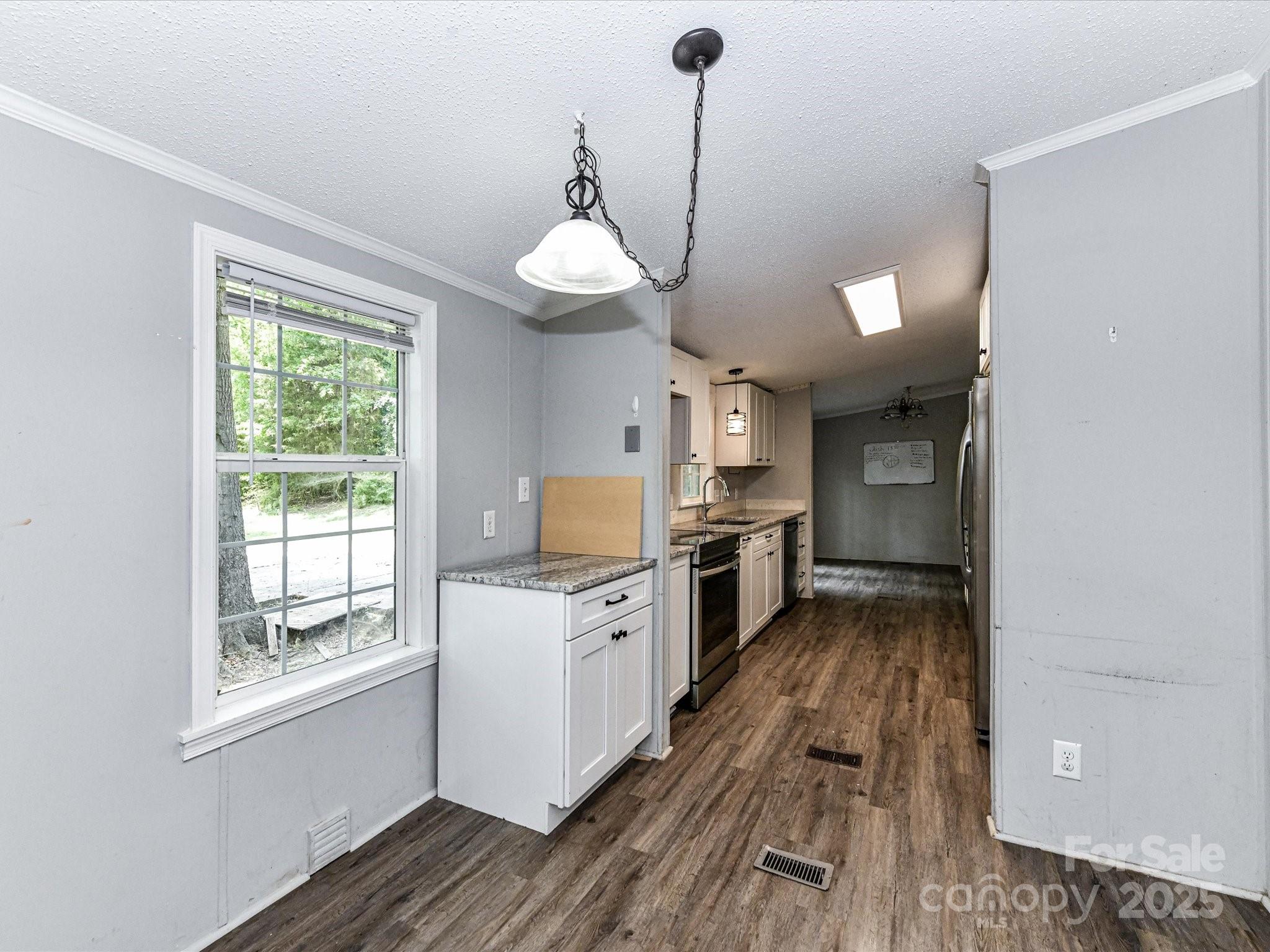 615 Hawley Road McConnells, SC 29726 - Photo 12 of 47 a kitchen with stainless steel appliances granite countertop a stove and a wooden floors