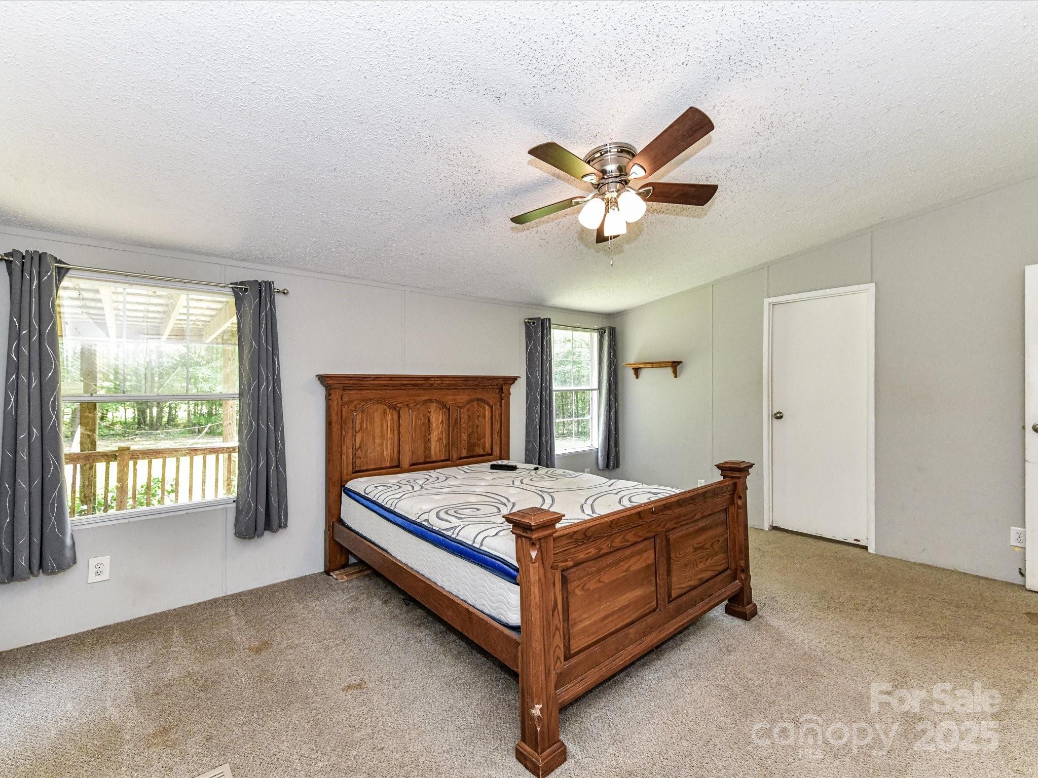 615 Hawley Road McConnells, SC 29726 - Photo 16 of 47 a bedroom with a bed and a ceiling fan