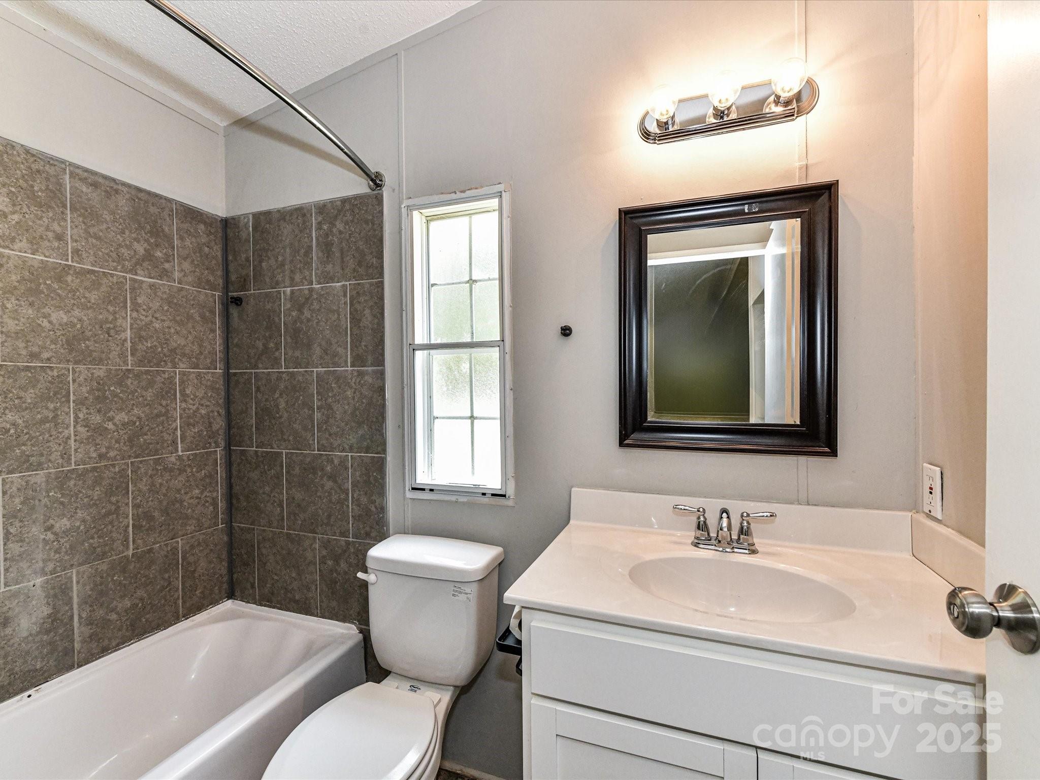 615 Hawley Road McConnells, SC 29726 - Photo 21 of 47 a bathroom with a toilet sink vanity tub and mirror