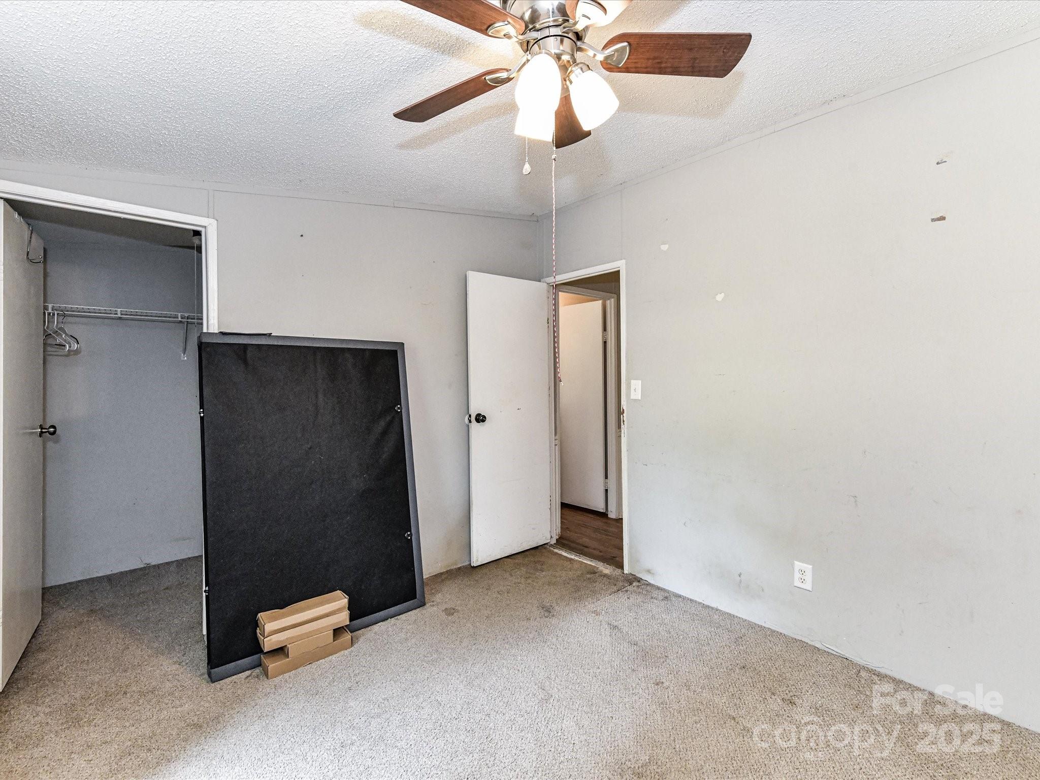 615 Hawley Road McConnells, SC 29726 - Photo 23 of 47 an empty room with closet and a chandelier fan