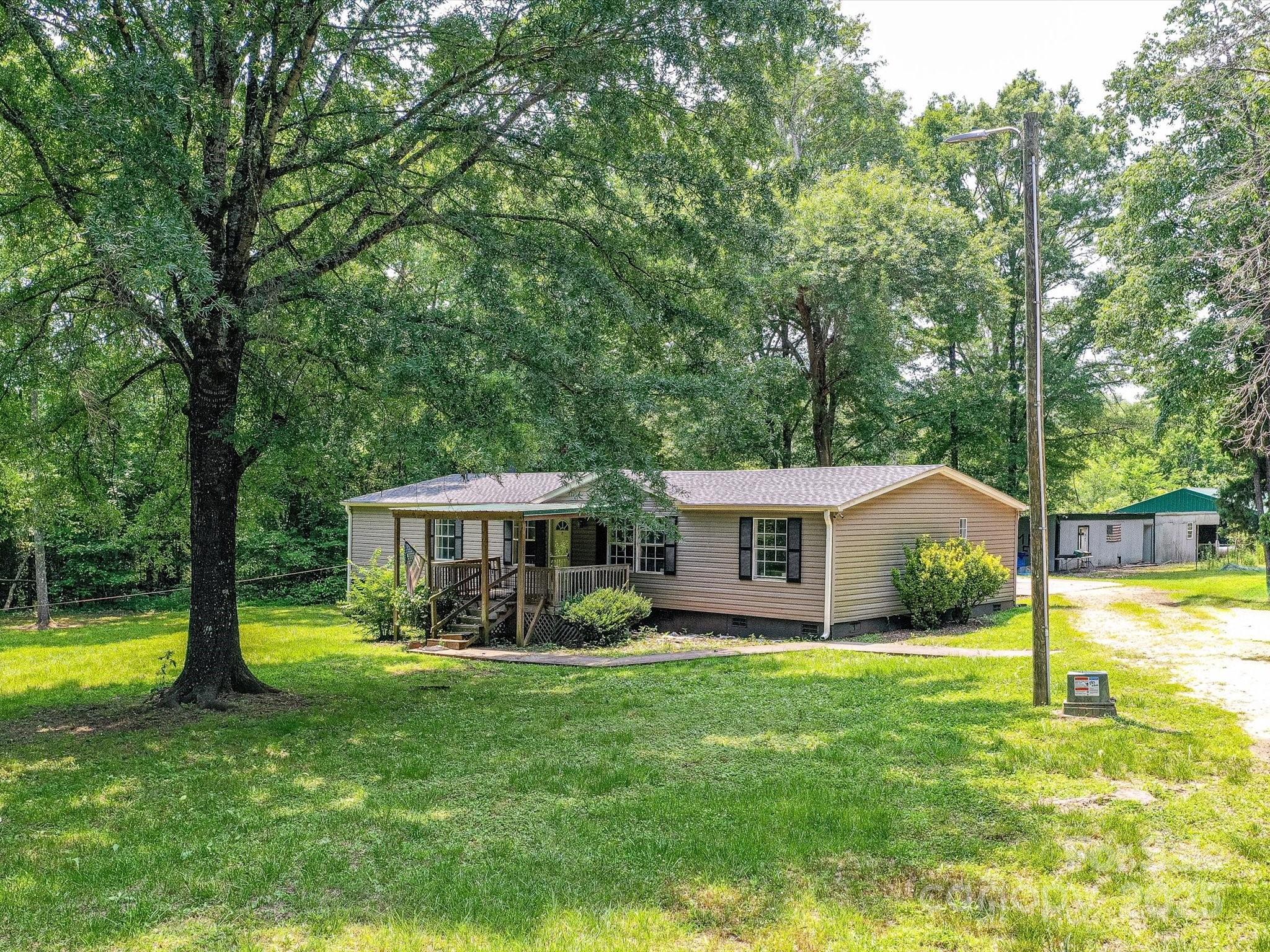 615 Hawley Road McConnells, SC 29726 - Photo 47 of 47 a view of a house with a big yard potted plants and large tree