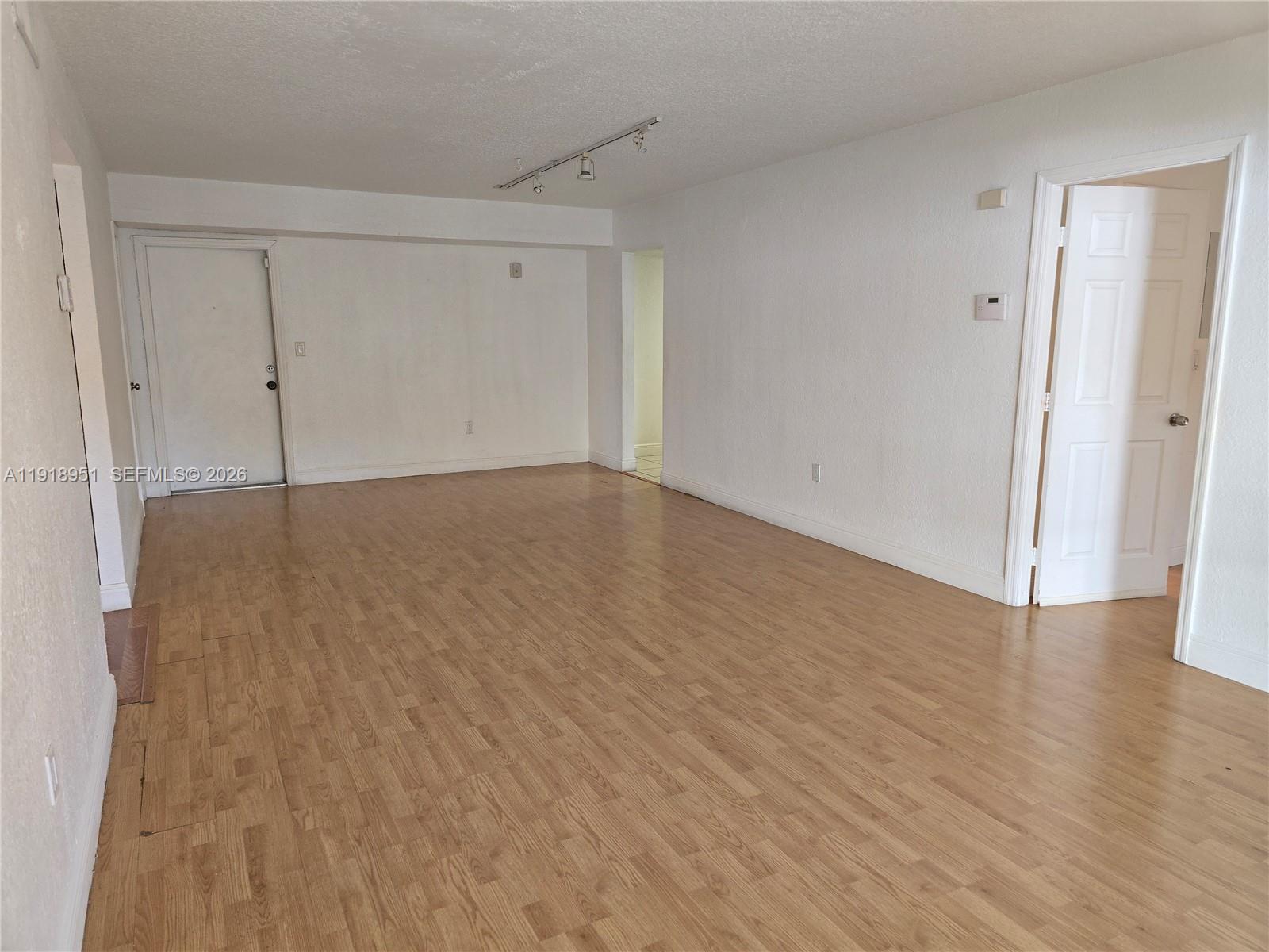 7925 Southwest 104th Street, Unit 201E Miami, FL 33156 - Photo 14 of 32 a view of an empty room with wooden floor