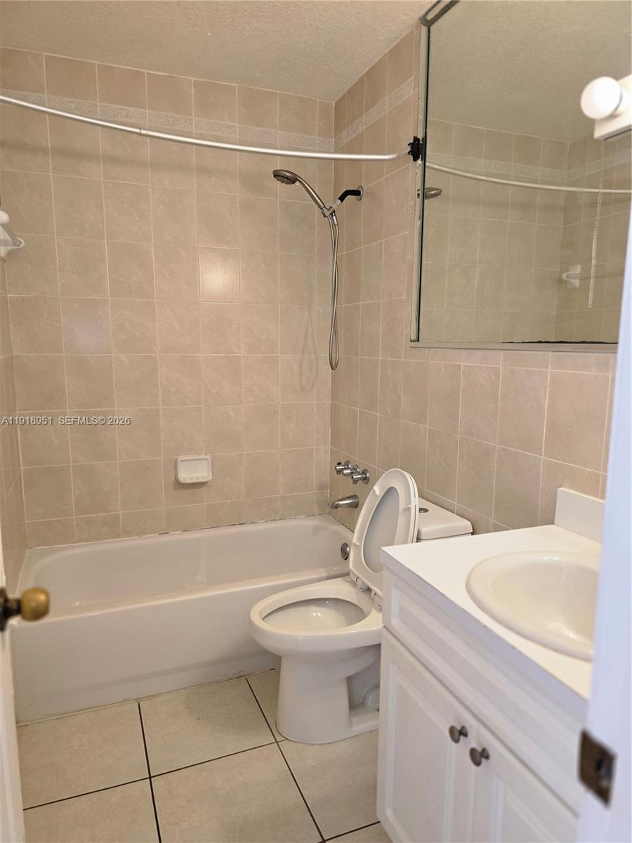7925 Southwest 104th Street, Unit 201E Miami, FL 33156 - Photo 20 of 32 a bathroom with a sink a toilet and shower