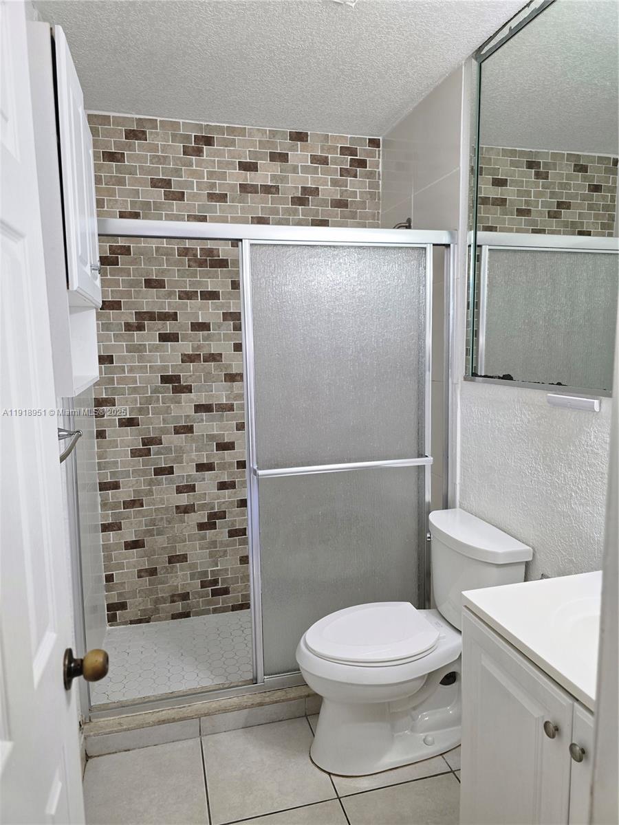 7925 Southwest 104th Street, Unit 201E Miami, FL 33156 - Photo 27 of 30 a bathroom with a toilet and a shower