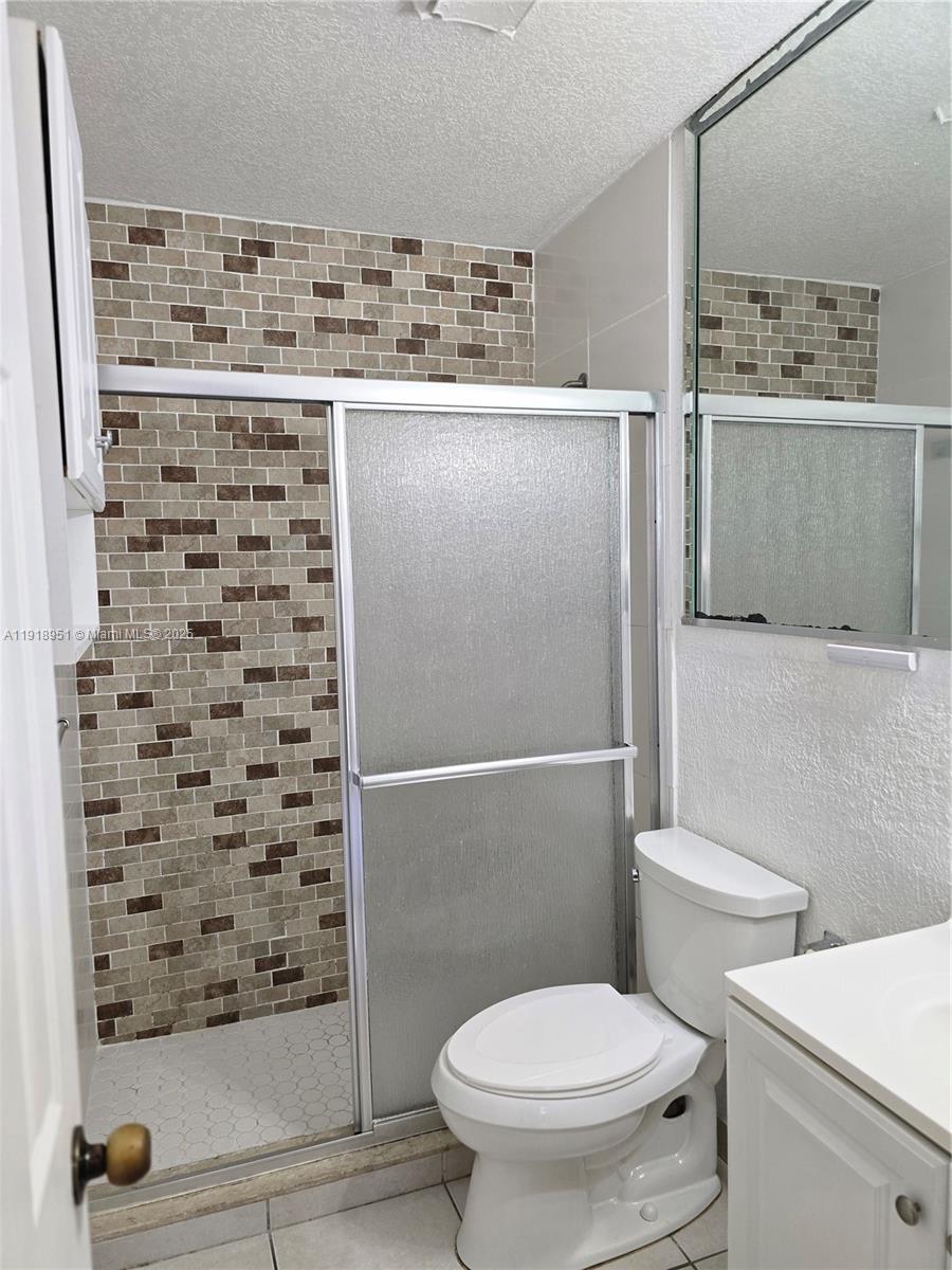 7925 Southwest 104th Street, Unit 201E Miami, FL 33156 - Photo 28 of 30 a bathroom with a toilet and a shower