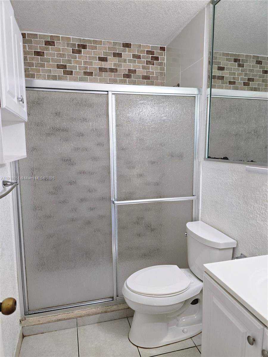 7925 Southwest 104th Street, Unit 201E Miami, FL 33156 - Photo 30 of 30 a bathroom with a toilet and a shower