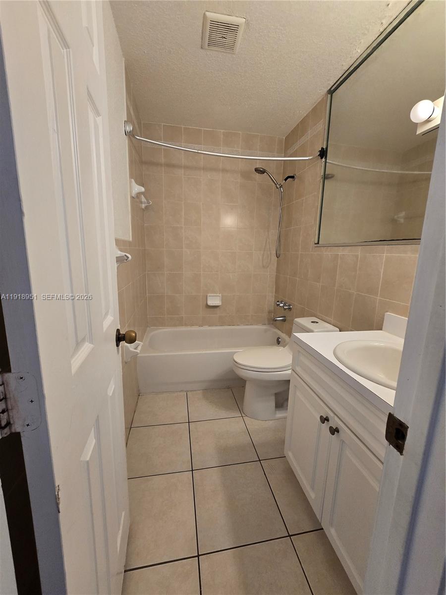 7925 Southwest 104th Street, Unit 201E Miami, FL 33156 - Photo 32 of 32 a bathroom with a granite countertop sink toilet and shower